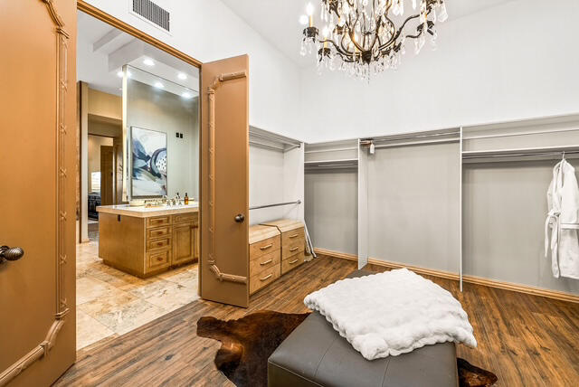 20 Vía Condotti Rancho Mirage, CA 92270 - Photo 28 of 40 a bedroom with a bed and wooden floor