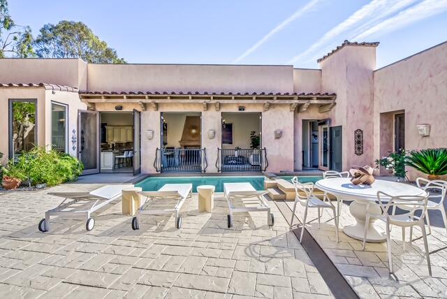 20 Vía Condotti Rancho Mirage, CA 92270 - Photo 38 of 40 a view of a patio with dining table and chairs with wooden floor