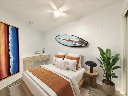 a bedroom with a large bed and a potted plant