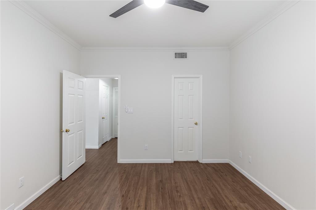12680 Hillcrest Road, Unit 4101 Dallas, TX 75230 - Photo 17 of 37 Room featuring wood-finish flooring, white walls, white trim, a ceiling fan, and multiple white paneled doors