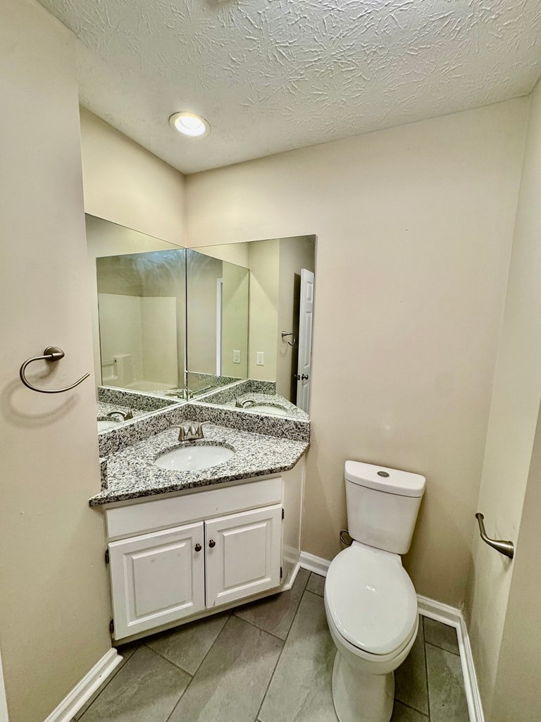 66 Ryan Loop Phenix City, AL 36869 - Photo 11 of 22 a bathroom with a granite countertop toilet and a sink