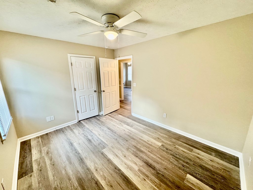 66 Ryan Loop Phenix City, AL 36869 - Photo 13 of 22 a view of an empty room with wooden floor and a window