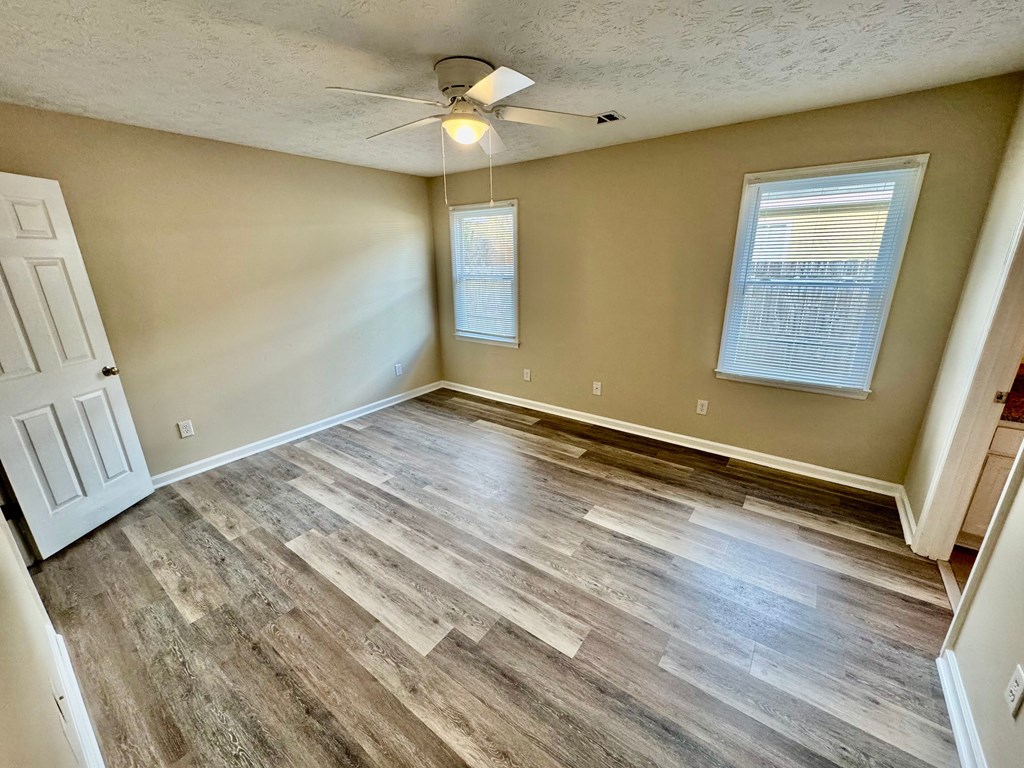 66 Ryan Loop Phenix City, AL 36869 - Photo 14 of 22 a view of room with window and wooden floor
