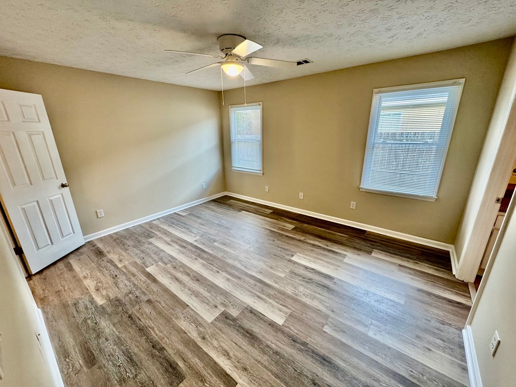 66 Ryan Loop Phenix City, AL 36869 - Photo 16 of 22 a view of an empty room with wooden floor and a window