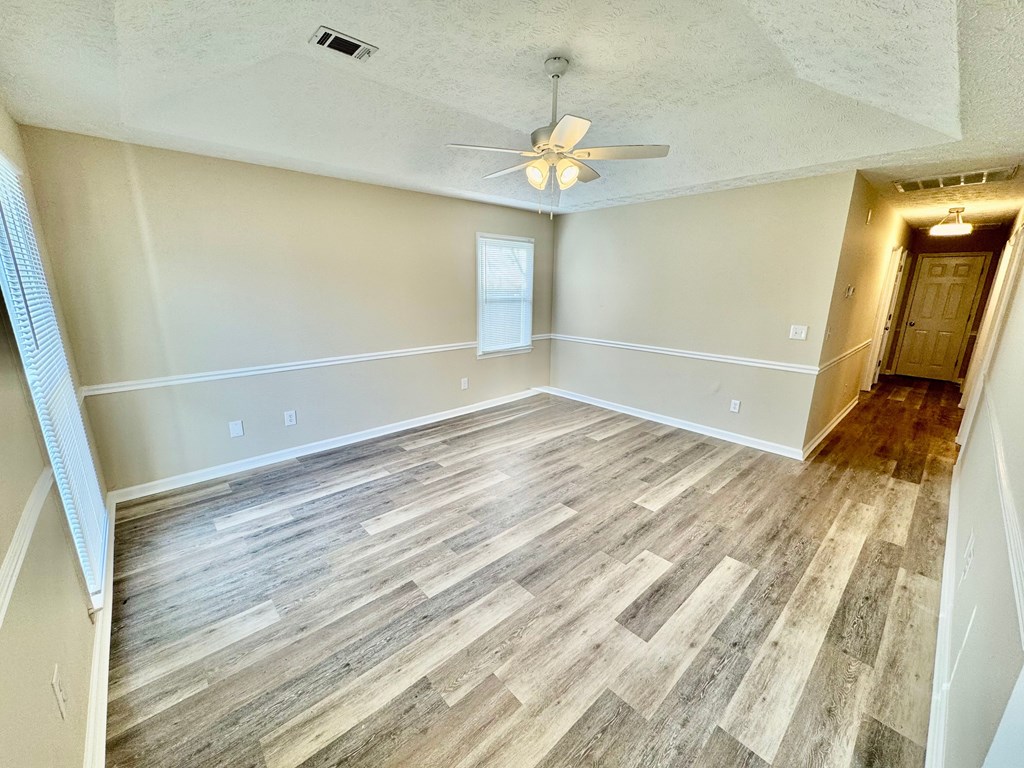 66 Ryan Loop Phenix City, AL 36869 - Photo 3 of 22 a view of an empty room with wooden floor and a window