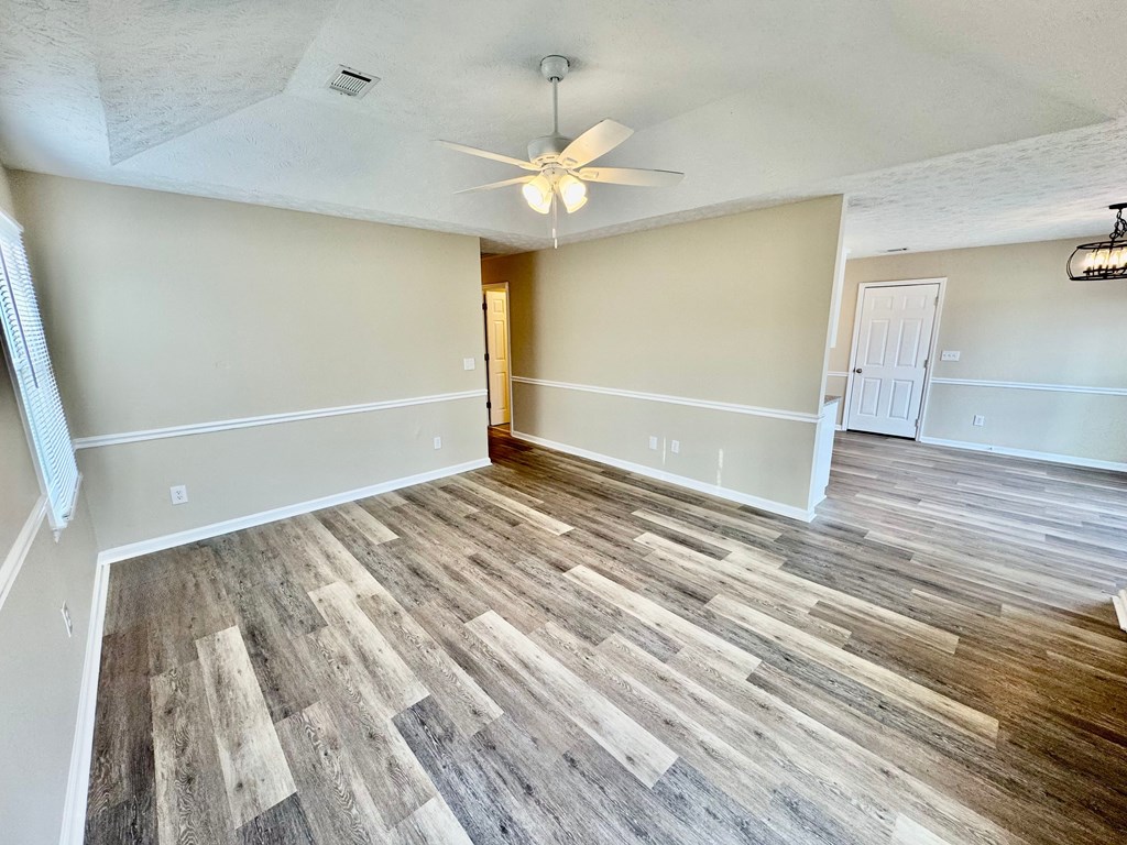 66 Ryan Loop Phenix City, AL 36869 - Photo 4 of 22 wooden floor in an empty room with a window