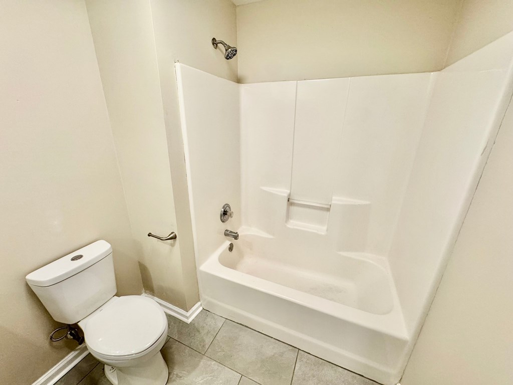 66 Ryan Loop Phenix City, AL 36869 - Photo 10 of 22 a white toilet sitting next to a bath tub