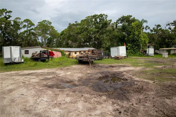 a view of a yard with car parked