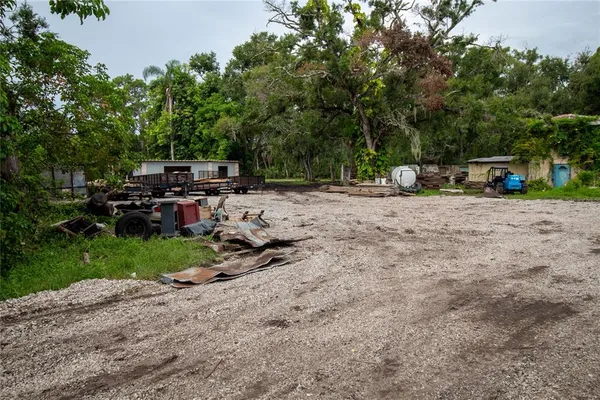 a view of a dirt road with a building