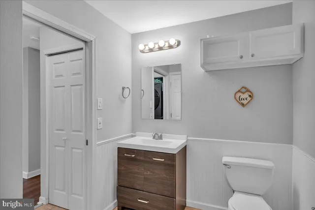 a bathroom with a toilet a sink and mirror