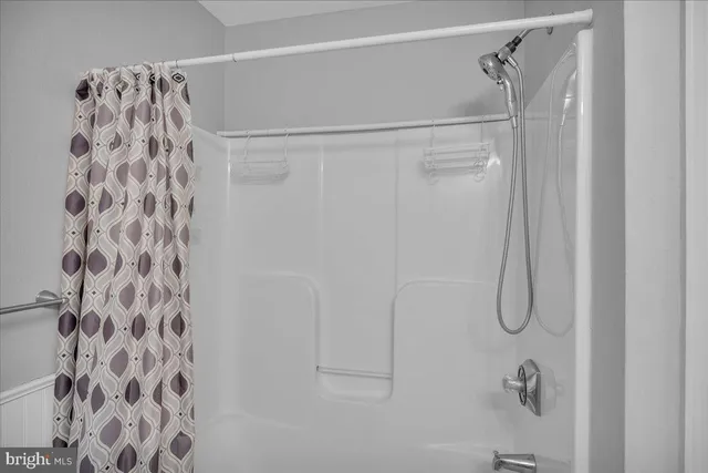 a bathroom with a shower curtain