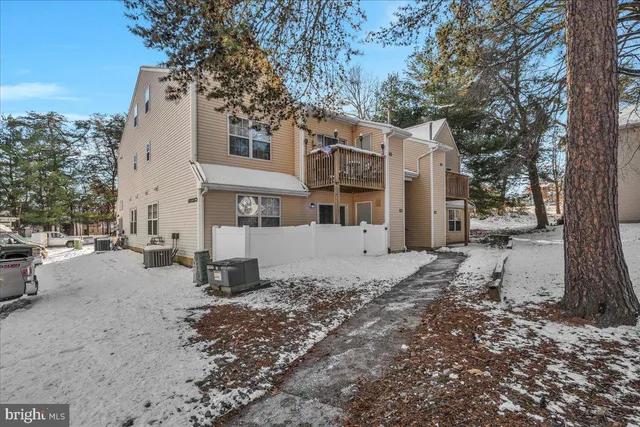 a view of a white house with a snow on the road