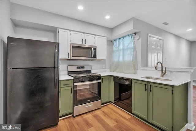 a kitchen with granite countertop a sink and steel appliances