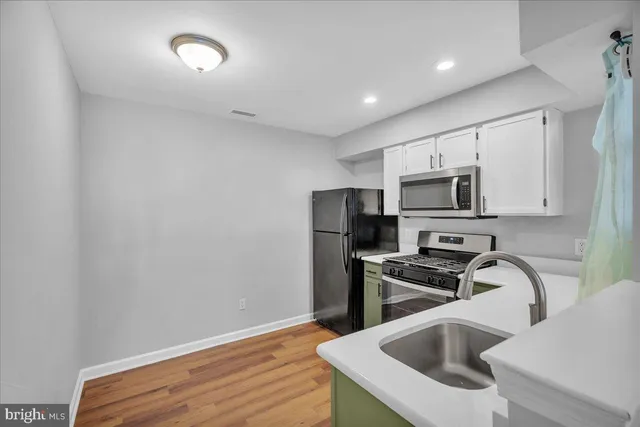 a kitchen with a sink cabinets and window