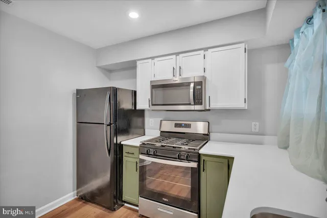 a kitchen with granite countertop a sink cabinets and window