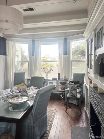 a living room with fireplace furniture and a large window