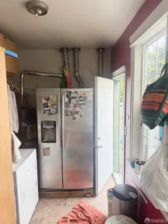 a refrigerator freezer sitting inside of a kitchen