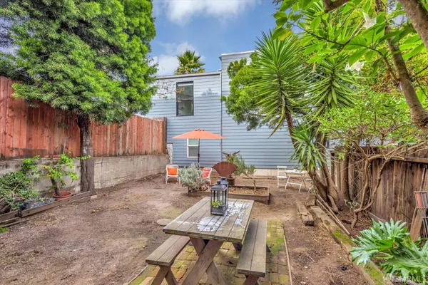 a view of a patio with table and chairs and potted plants