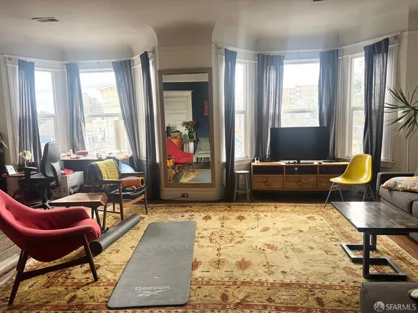 a living room with furniture rug and a window