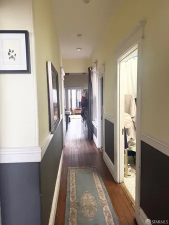 a view of a hallway view with wooden floor and staircase