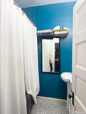 a view of bathroom with a sink and mirror