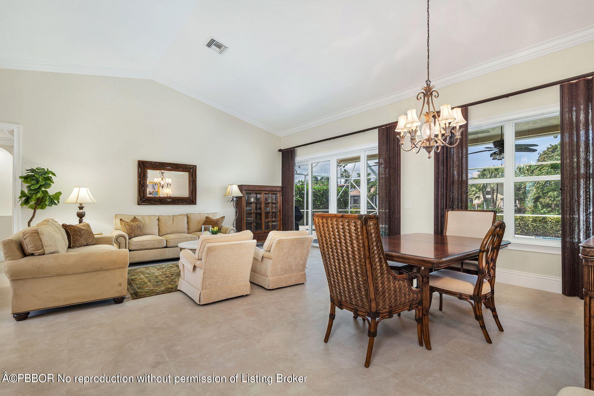 8774 Southeast Riverfront Terrace Tequesta, FL 33469 - Photo 11 of 45 a living room with furniture and a chandelier