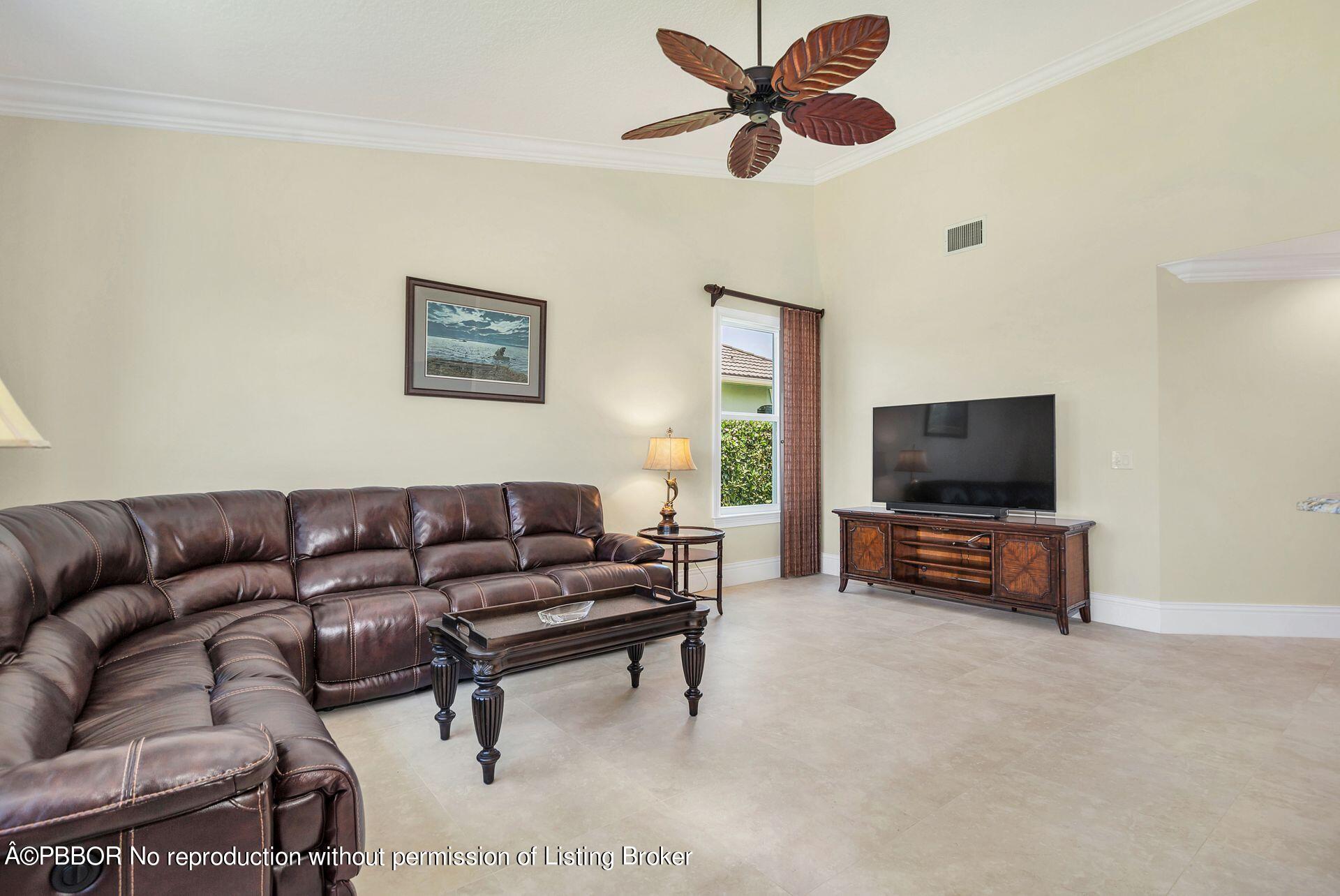 8774 Southeast Riverfront Terrace Tequesta, FL 33469 - Photo 12 of 45 a living room with furniture and a flat screen tv