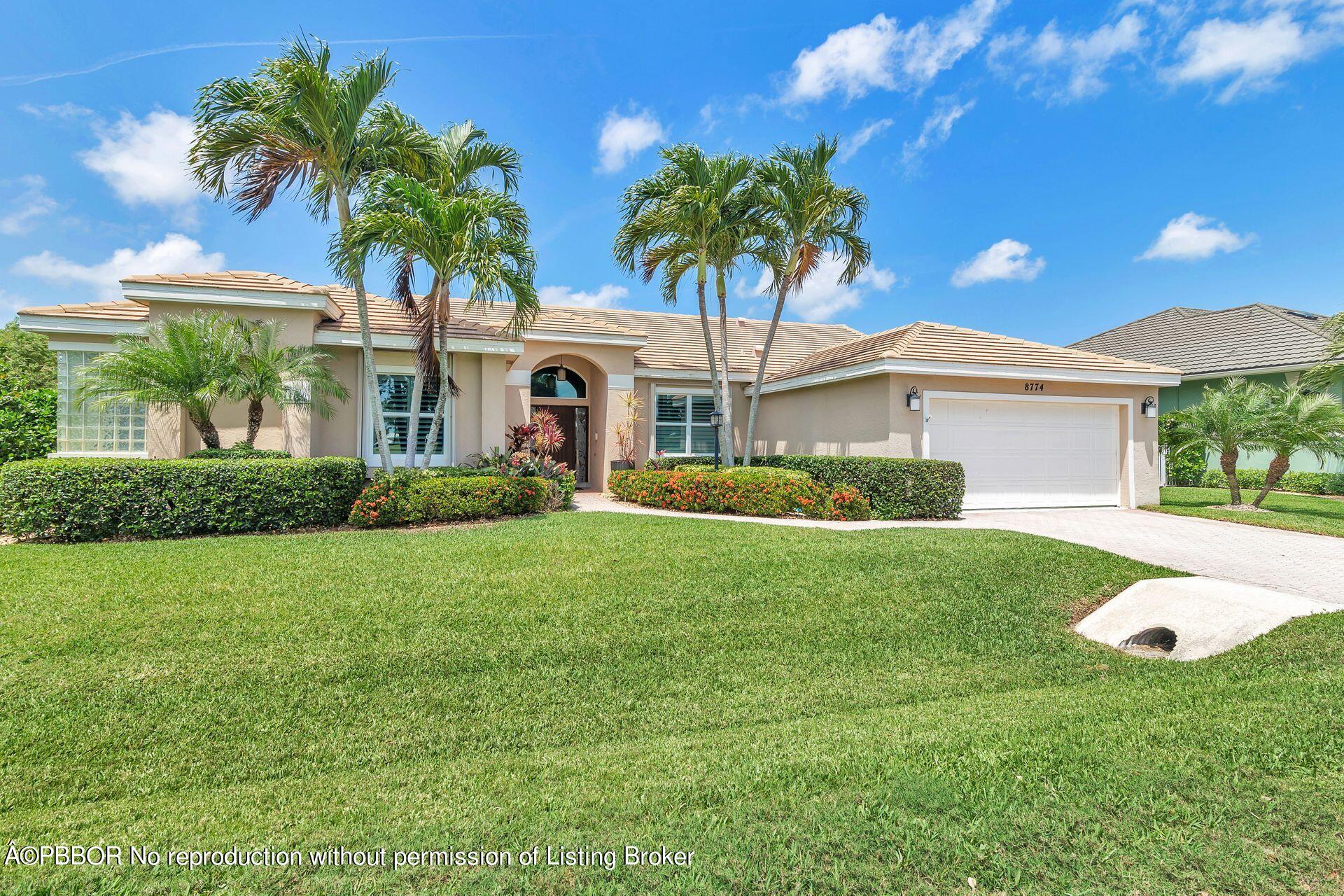 8774 Southeast Riverfront Terrace Tequesta, FL 33469 - Photo 18 of 45 a front view of house with yard and green space