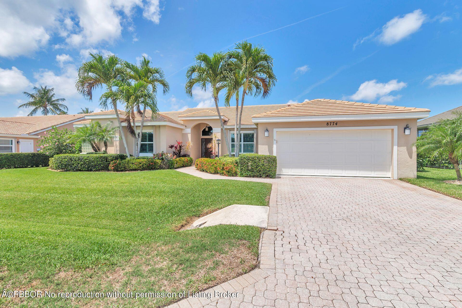 8774 Southeast Riverfront Terrace Tequesta, FL 33469 - Photo 19 of 45 a front view of house with yard and green space