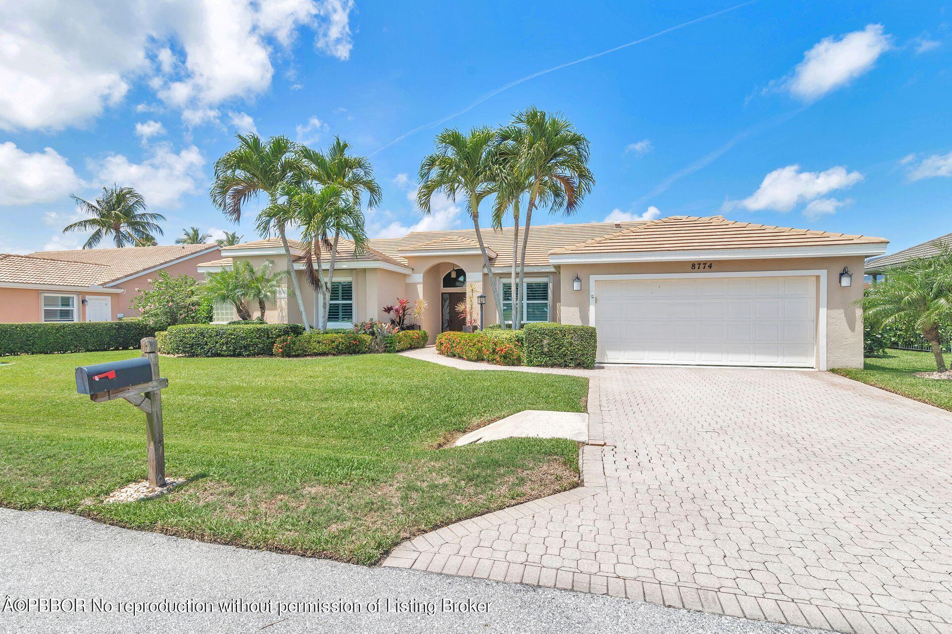 8774 Southeast Riverfront Terrace Tequesta, FL 33469 - Photo 20 of 45 a front view of house with yard and green space