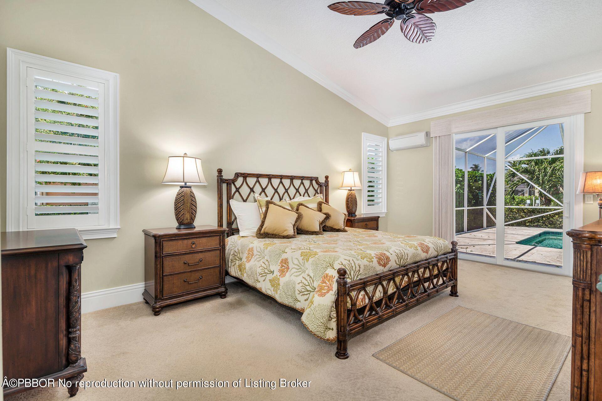 8774 Southeast Riverfront Terrace Tequesta, FL 33469 - Photo 21 of 45 a bedroom with a bed chandelier and a window