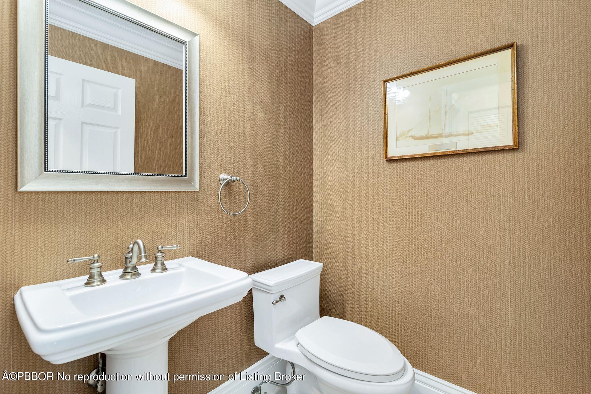 8774 Southeast Riverfront Terrace Tequesta, FL 33469 - Photo 26 of 45 a bathroom with a toilet a sink and mirror