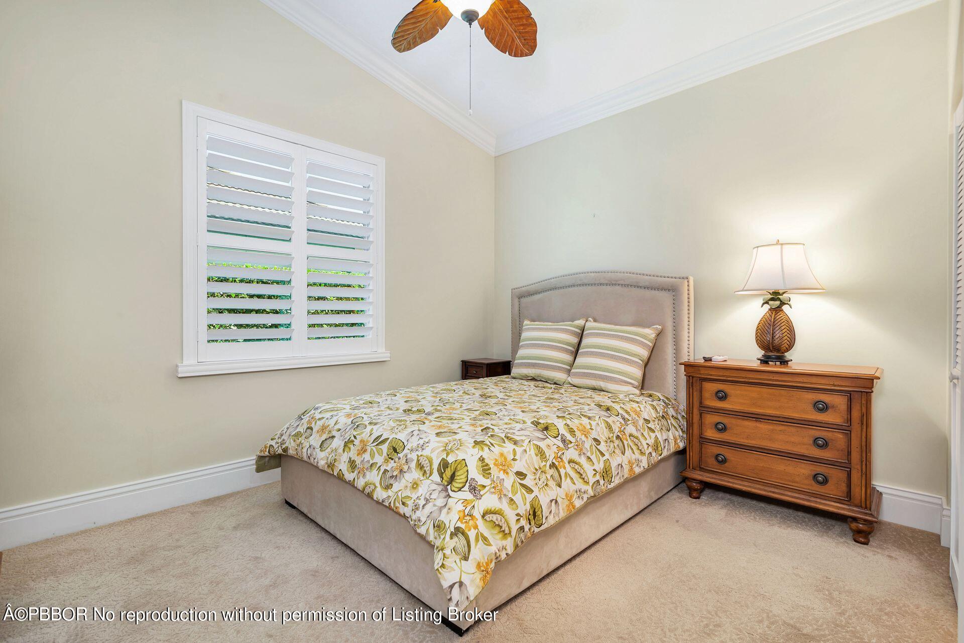 8774 Southeast Riverfront Terrace Tequesta, FL 33469 - Photo 27 of 45 a bedroom with a bed and window