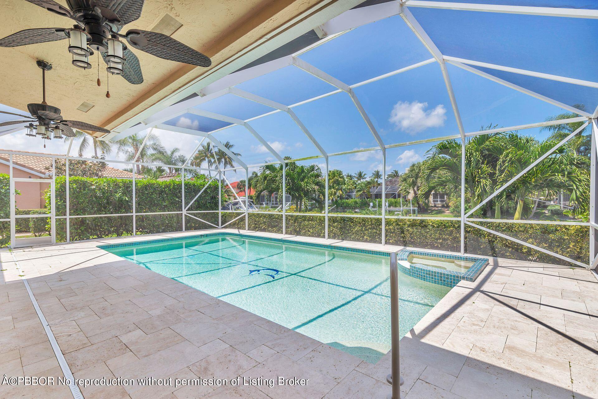 8774 Southeast Riverfront Terrace Tequesta, FL 33469 - Photo 30 of 45 a view of a backyard with a swimming pool