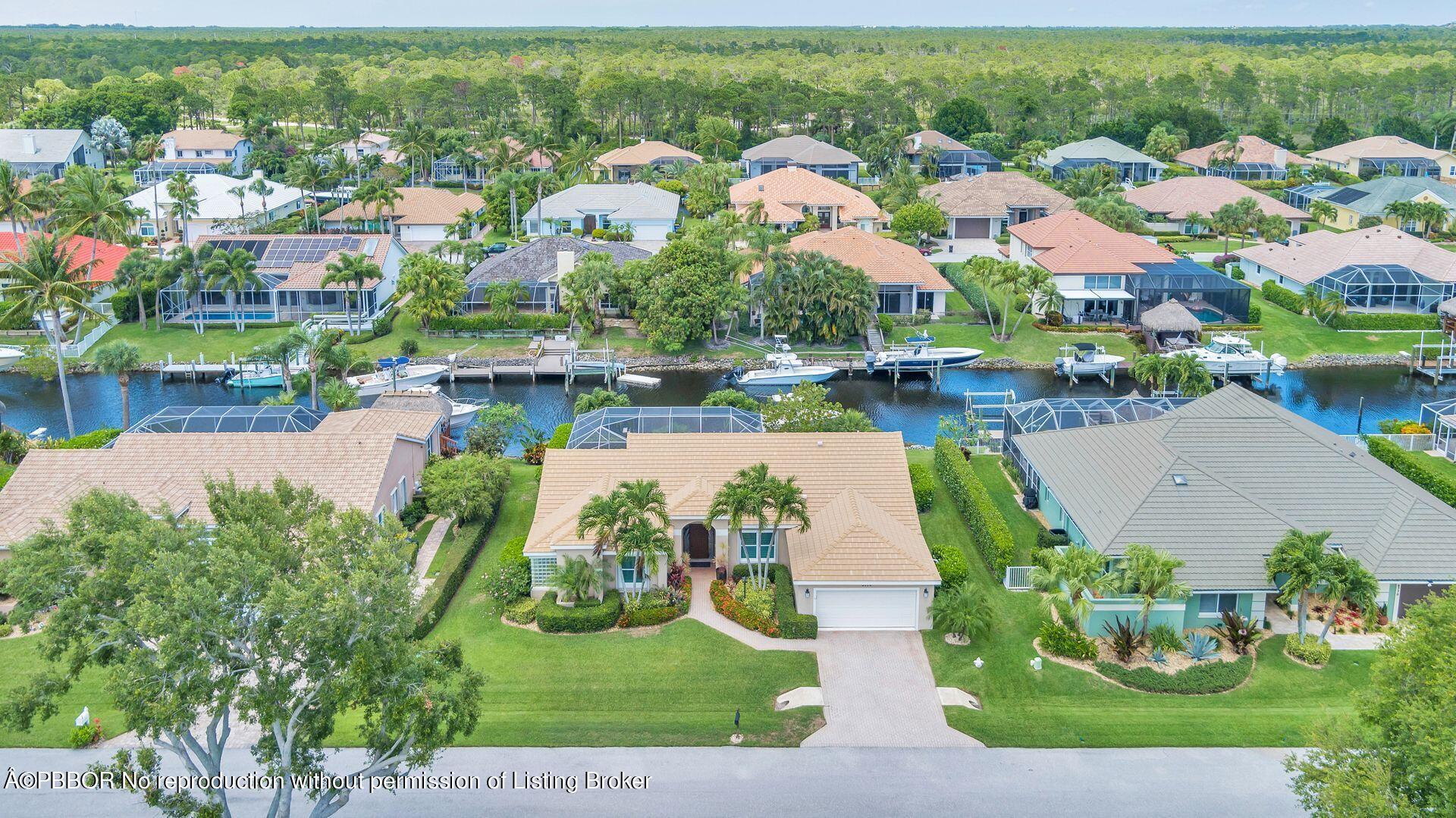 8774 Southeast Riverfront Terrace Tequesta, FL 33469 - Photo 42 of 45 an aerial view of house with yard swimming pool and outdoor seating