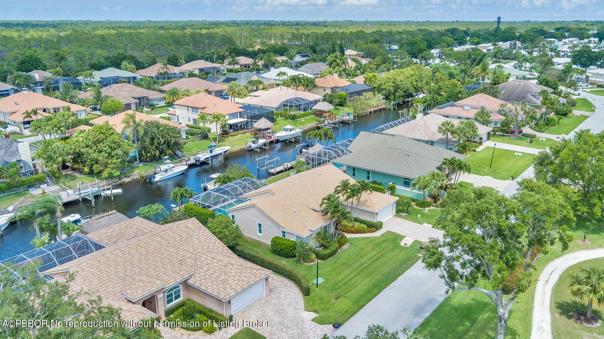 8774 Southeast Riverfront Terrace Tequesta, FL 33469 - Photo 43 of 45 an aerial view of residential houses with outdoor space and street view