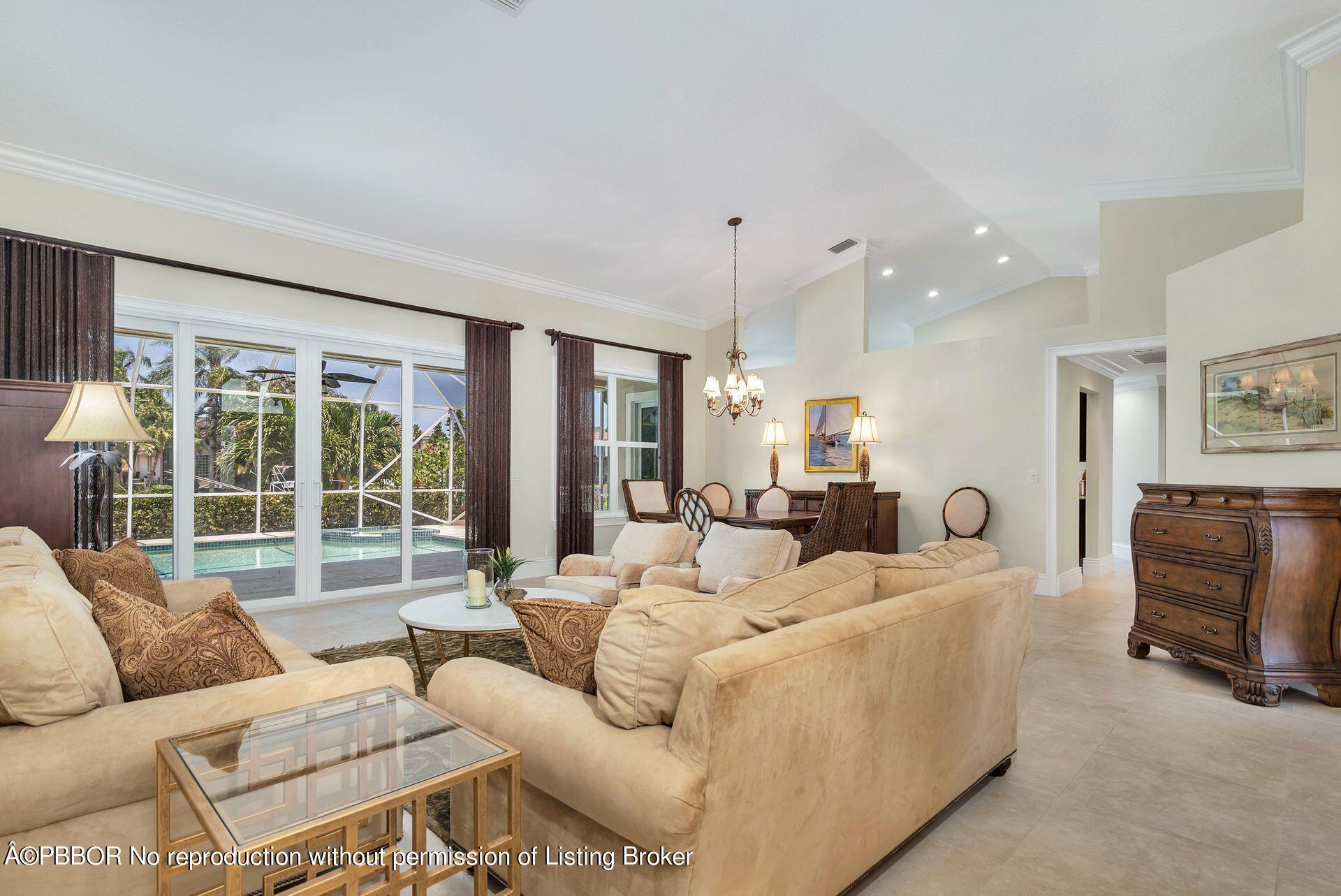 8774 Southeast Riverfront Terrace Tequesta, FL 33469 - Photo 8 of 45 a living room with furniture and large windows