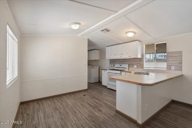 a kitchen with granite countertop white cabinets and white appliances