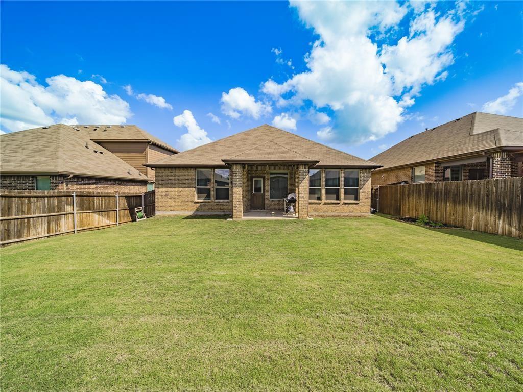 1809 Spinnaker Drive Denton, TX 76210 - Photo 16 of 18 a front view of a house with a garden