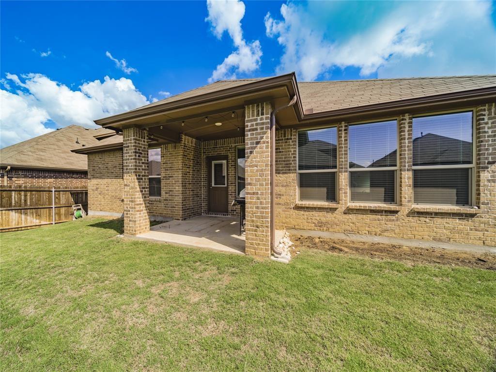 1809 Spinnaker Drive Denton, TX 76210 - Photo 17 of 18 front view of a house with a yard