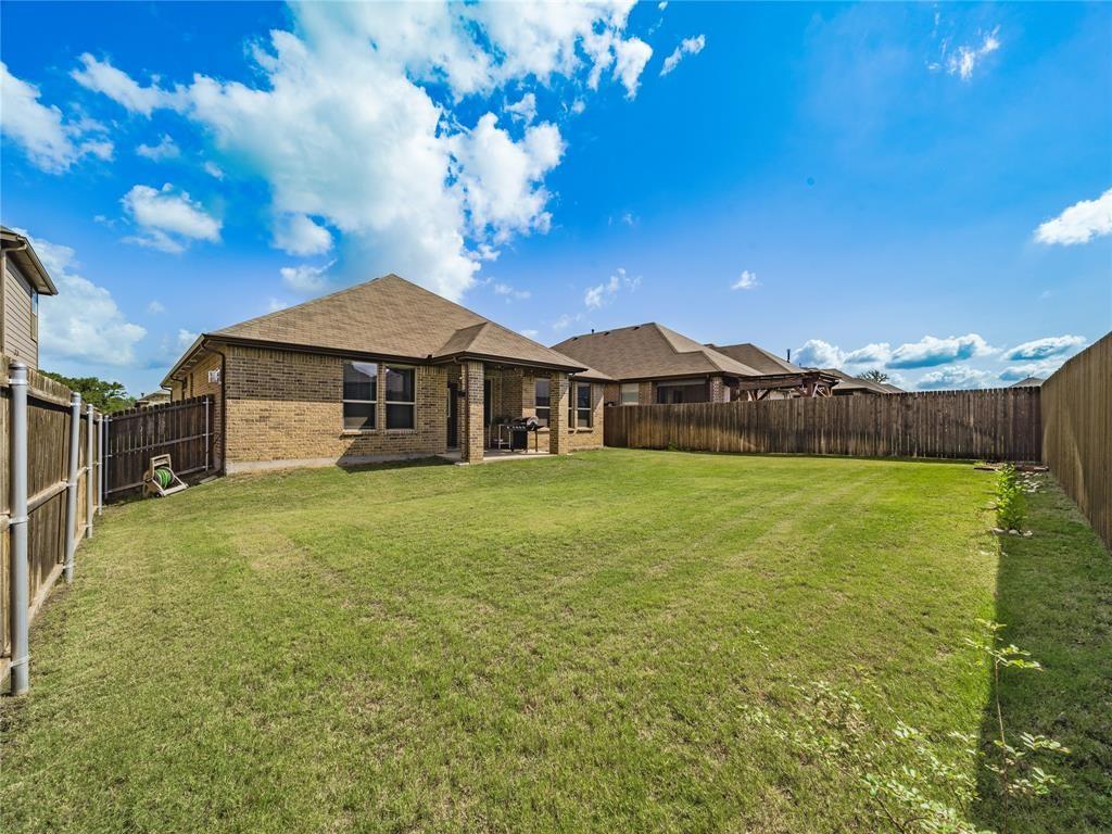 1809 Spinnaker Drive Denton, TX 76210 - Photo 18 of 18 a front view of a house with garden