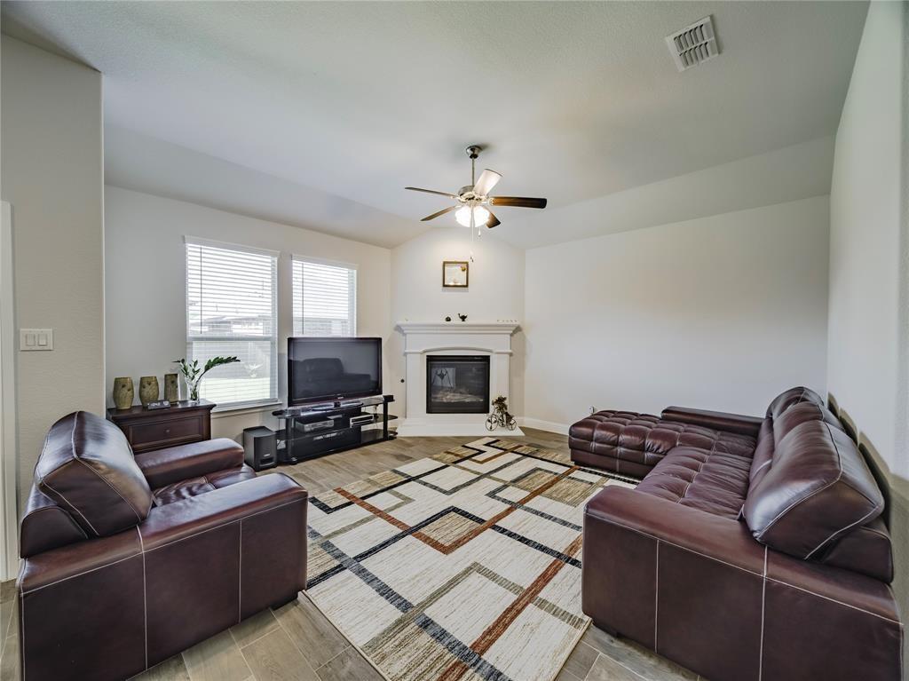 1809 Spinnaker Drive Denton, TX 76210 - Photo 8 of 18 a living room with furniture ceiling fan and a fireplace