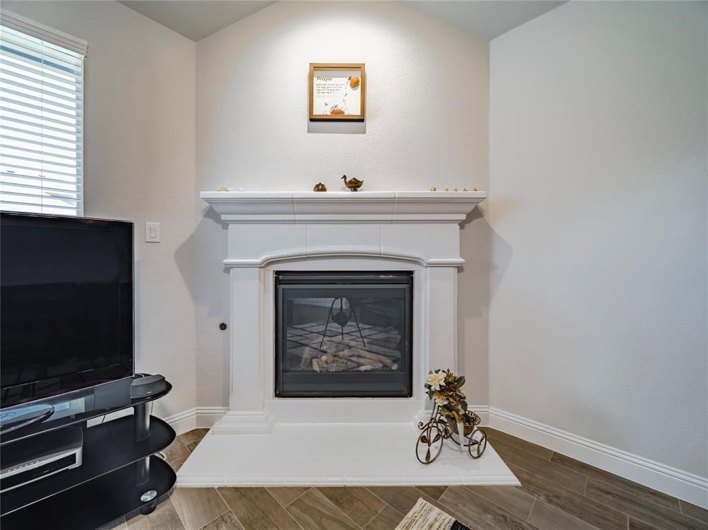 1809 Spinnaker Drive Denton, TX 76210 - Photo 9 of 18 a living room with furniture a flat screen tv and a fireplace