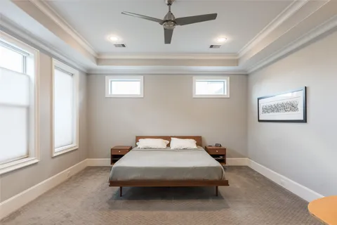 a bedroom with a bed and a ceiling fan