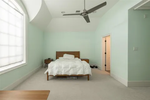 a bedroom with a bed and window