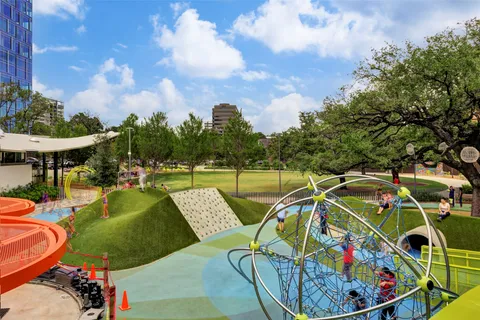 a view of building with small space and a car park in front of it