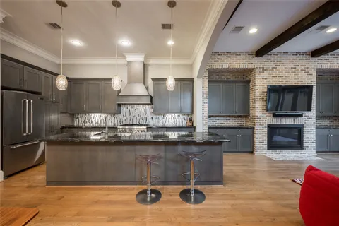 a kitchen with stainless steel appliances granite countertop a sink wooden cabinets and a granite counter tops