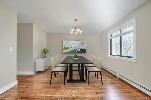 a view of a dining room with furniture window and wooden floor