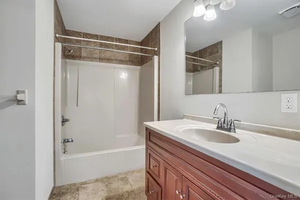 a bathroom with a sink a mirror and a bathtub