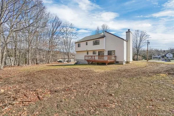 a view of a house with a yard covered in snow